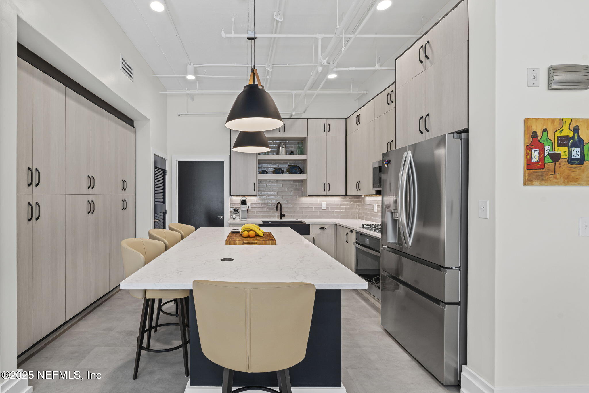 1661 Riverside Avenue, Unit 214 Jacksonville, FL 32204 - Photo 31 of 96 a kitchen with stainless steel appliances a refrigerator a sink dishwasher a stove and a dining table with wooden floor