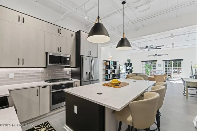 a view of a roof deck with table and chairs with wooden floor
