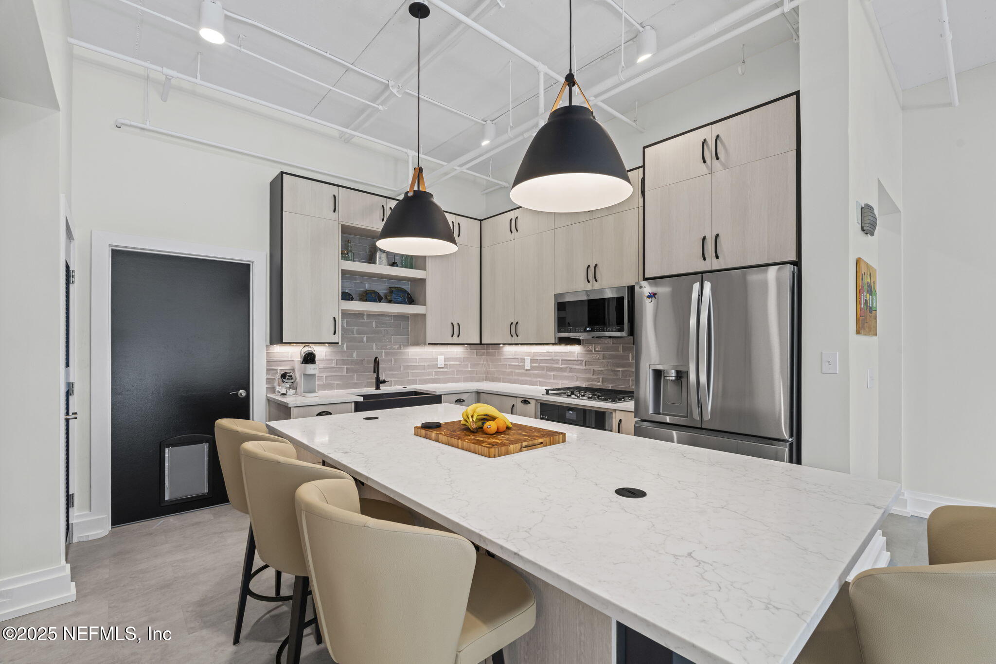 1661 Riverside Avenue, Unit 214 Jacksonville, FL 32204 - Photo 37 of 96 a kitchen with stainless steel appliances a sink a stove a refrigerator cabinets and wooden floor