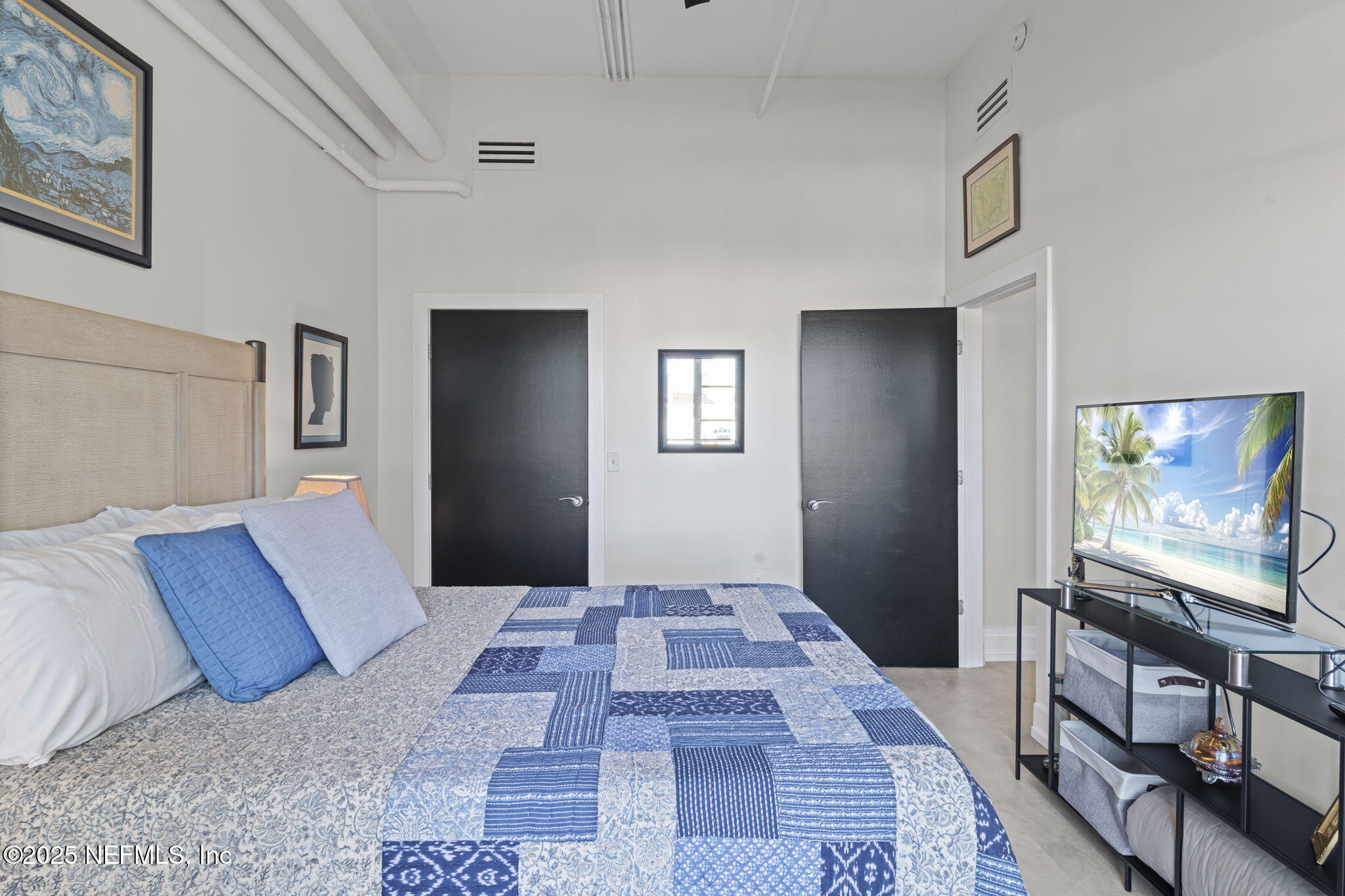 1661 Riverside Avenue, Unit 214 Jacksonville, FL 32204 - Photo 51 of 96 a bedroom with a bed and a flat screen tv