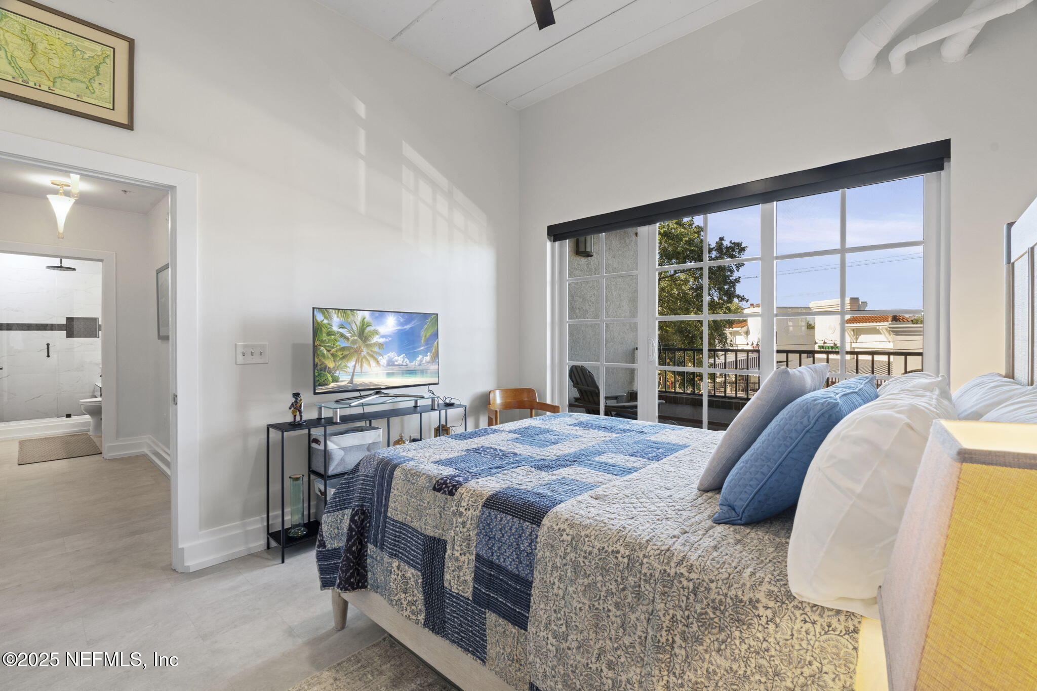 1661 Riverside Avenue, Unit 214 Jacksonville, FL 32204 - Photo 52 of 96 a bedroom with a bed and a flat tv screen next to a window