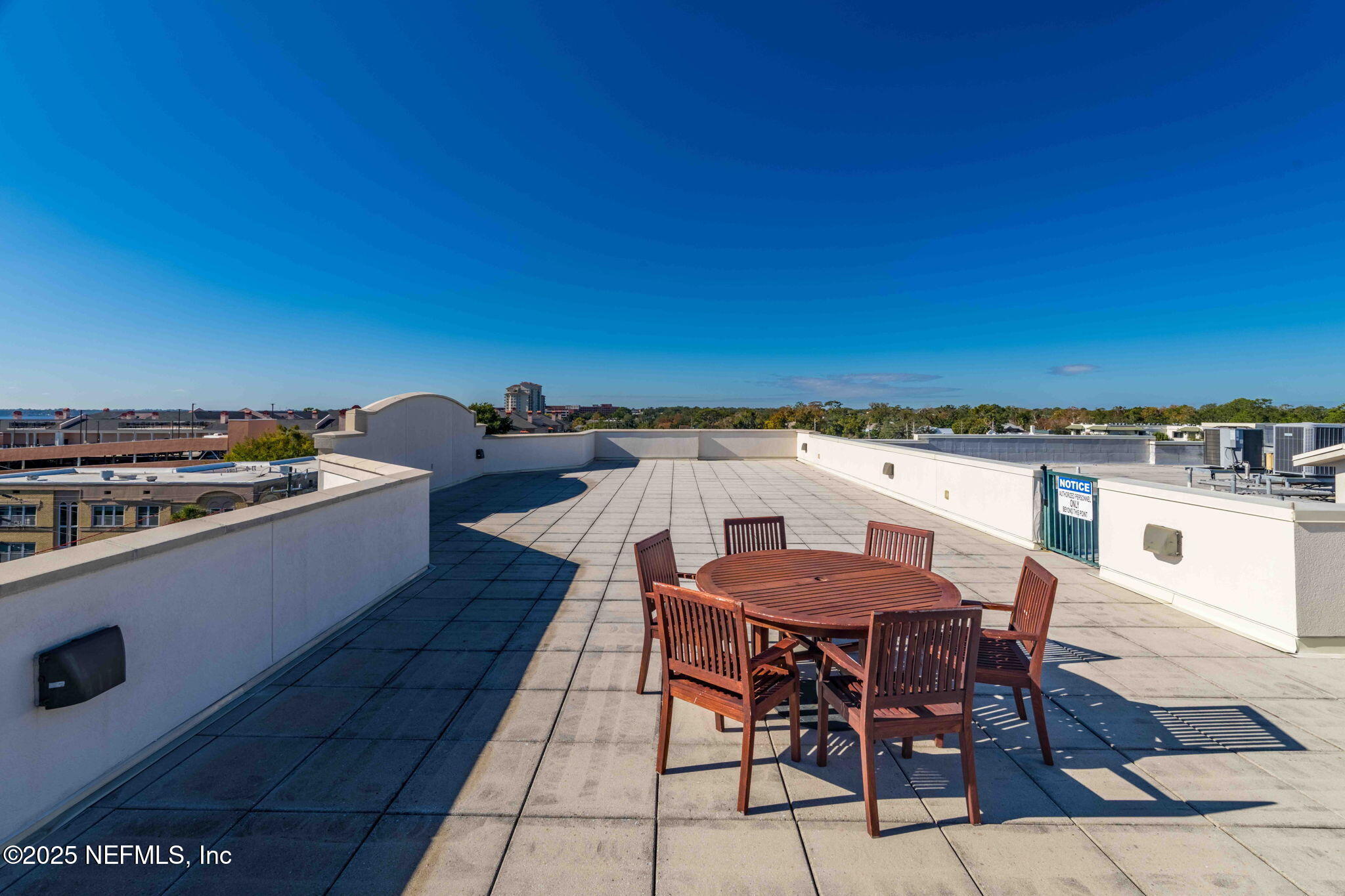 1661 Riverside Avenue, Unit 214 Jacksonville, FL 32204 - Photo 61 of 96 a view of a roof deck with table and chairs with wooden floor