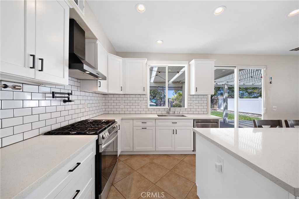 31207 Bell Mountain Road Menifee, CA 92584 - Photo 5 of 60 Kitchen With Stainless Steel Appliances And Backyard Access
