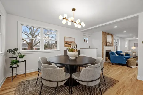 a dining room with furniture a window and wooden floor