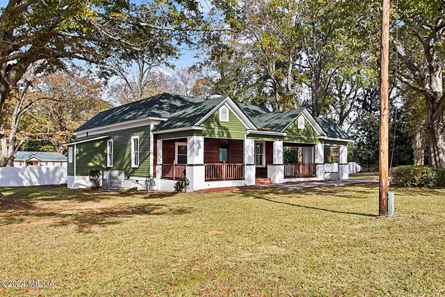 a front view of a house with a yard table and chairs