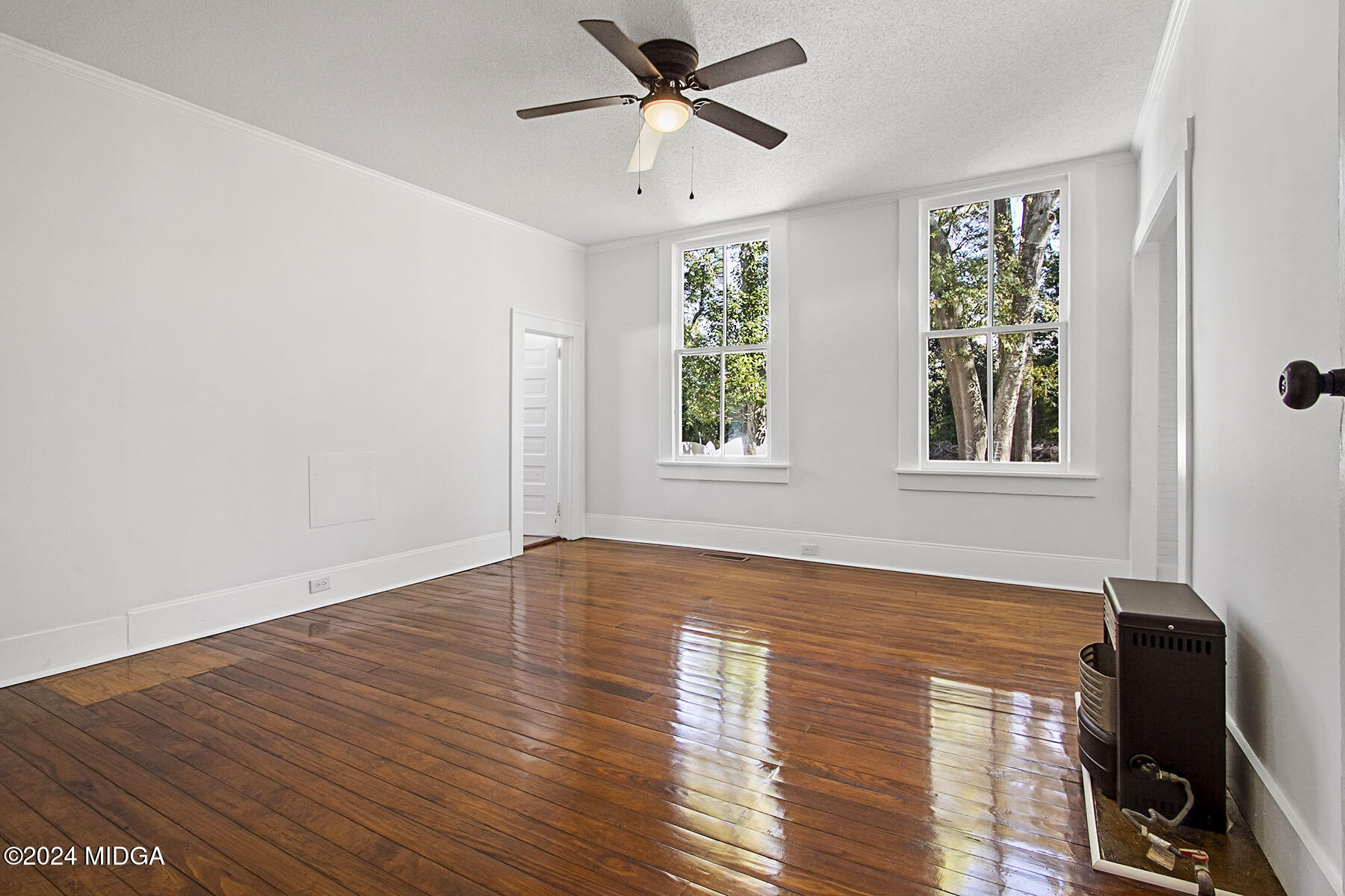 236 Old Clinton Road Gray, GA 31032 - Photo 12 of 27 a view of an empty room with wooden floor and a window
