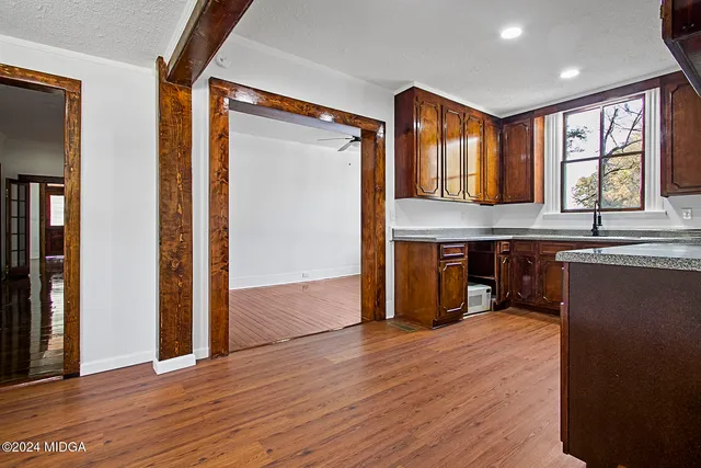 a view of kitchen with furniture and wooden floor