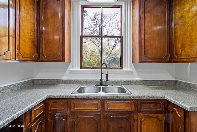 a kitchen with stainless steel appliances granite countertop a sink and a cabinets