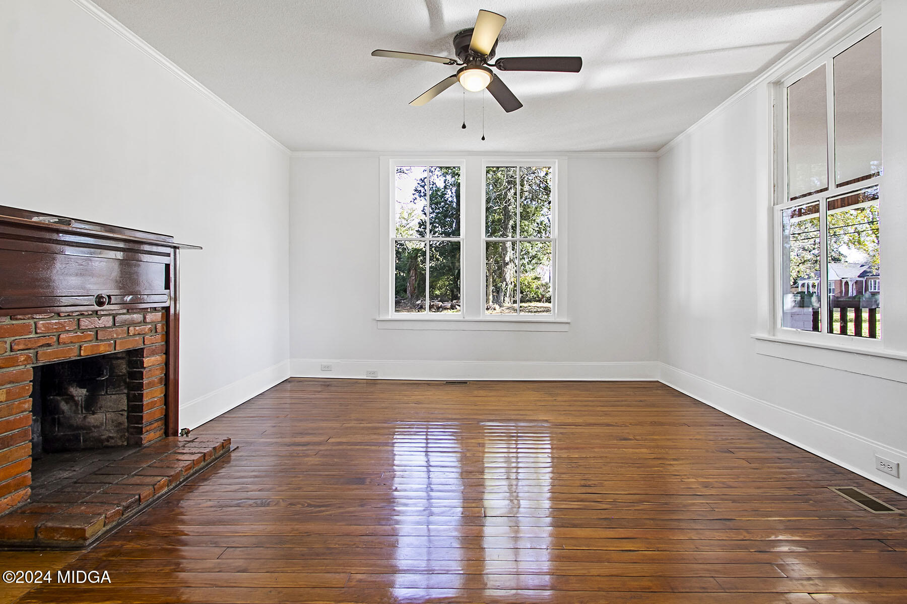 236 Old Clinton Road Gray, GA 31032 - Photo 6 of 27 a view of empty room with wooden floor and fireplace