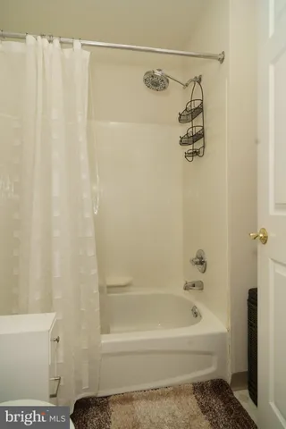 a bathroom with a shower curtain and a bathtub