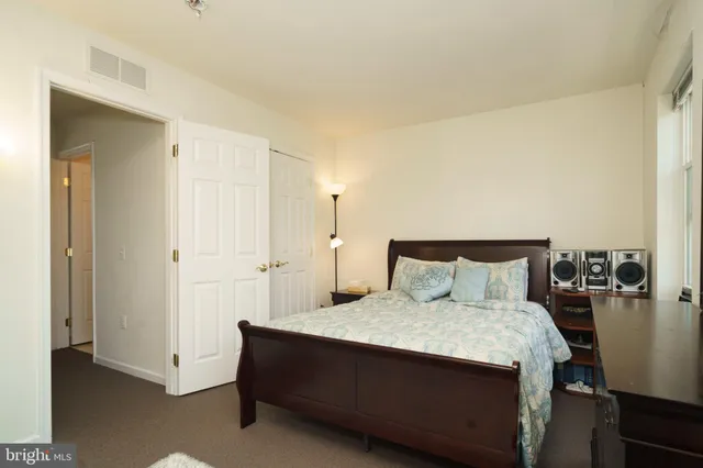 a bedroom with a bed and a table