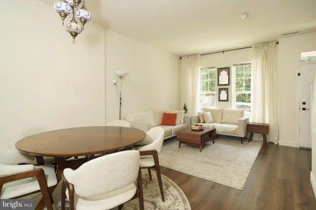 a living room with furniture a table and a chandelier