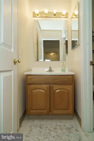 a bathroom with a sink vanity and a mirror