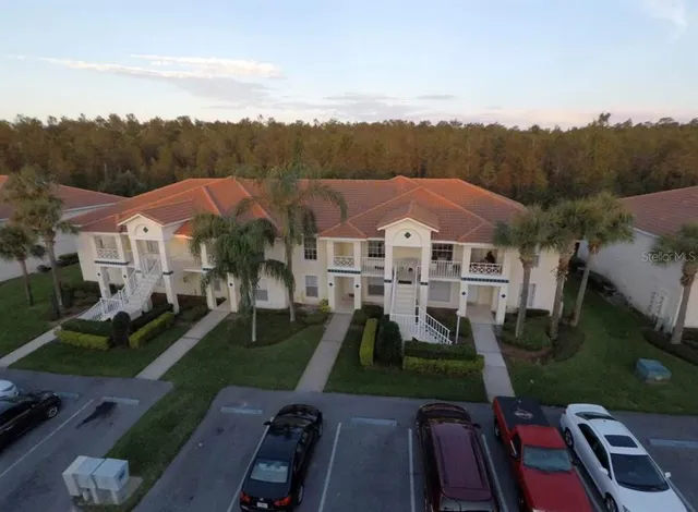 an aerial view of multiple houses with a yard