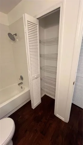 a bathroom with a bathtub and a toilet