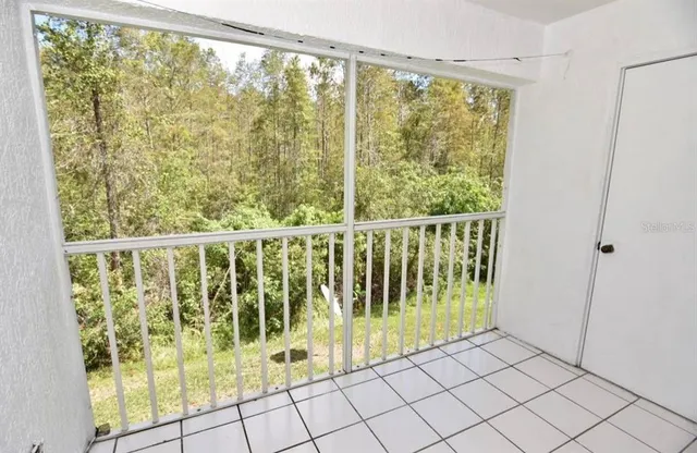 a view of a porch with wooden floor