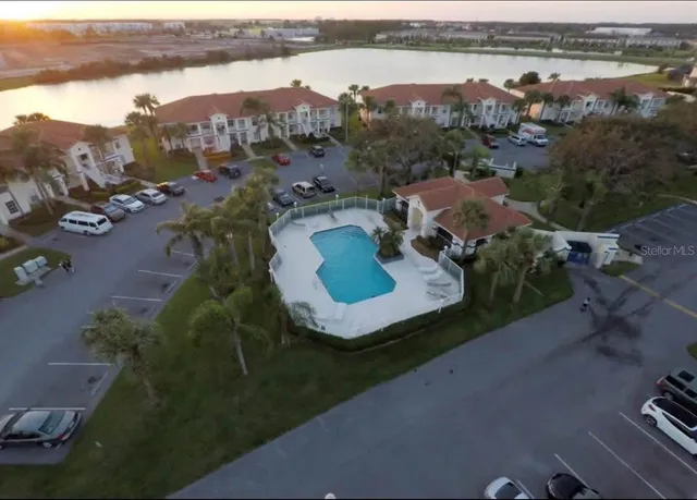 an aerial view of residential houses with outdoor space and river