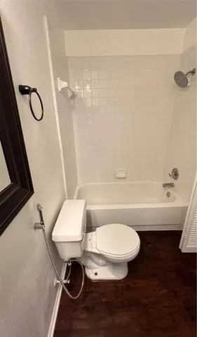 a bathroom with a bath tub and a toilet