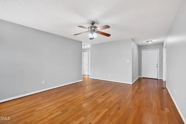 a kitchen with granite countertop a sink a stove and cabinets