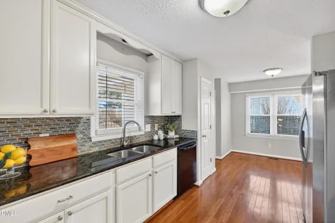 a kitchen with stainless steel appliances granite countertop a sink stove and granite counter top