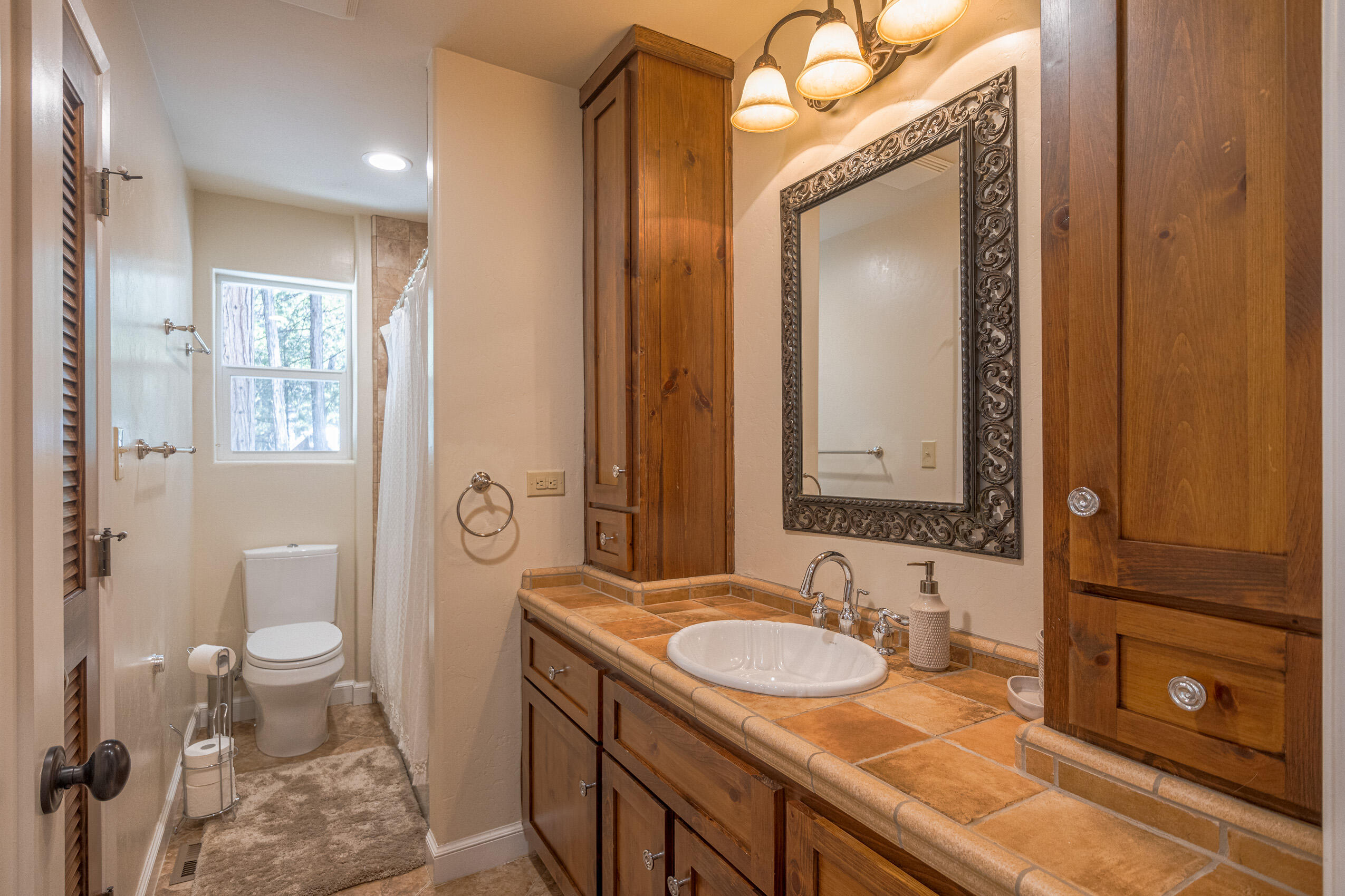 11809 Pine Drive Wofford Heights, CA 93285 - Photo 27 of 33 a bathroom with a granite countertop sink toilet and shower