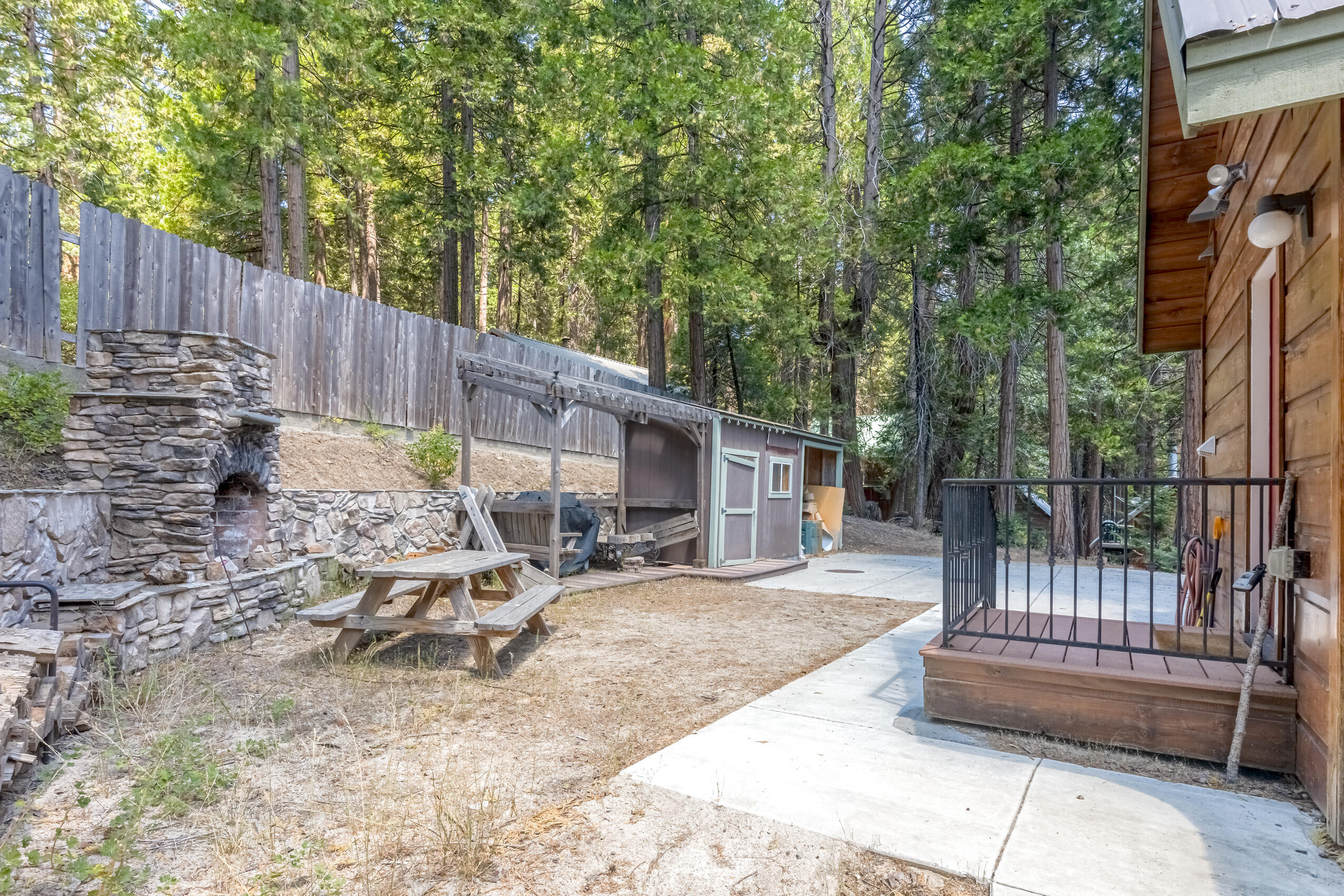 11809 Pine Drive Wofford Heights, CA 93285 - Photo 32 of 33 a view of a chair and tables in the back yard of the house