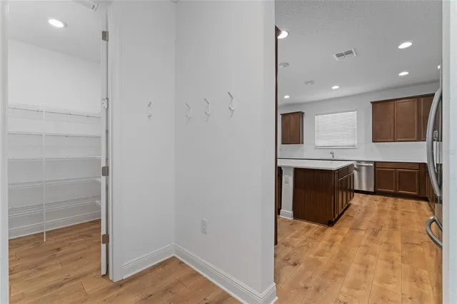 a view of a kitchen with a sink and a refrigerator