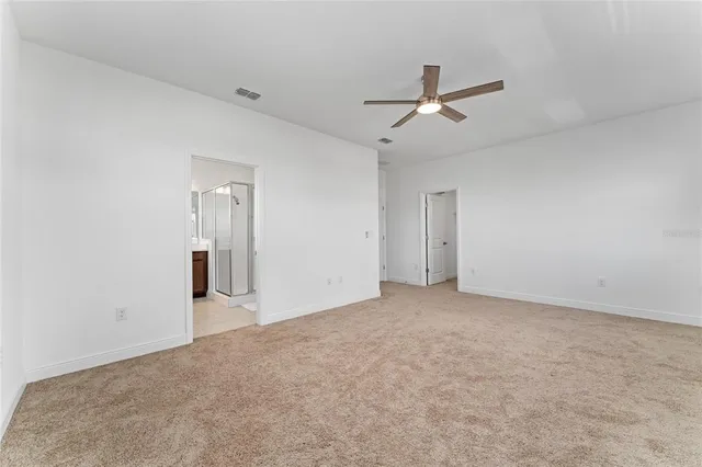an empty room with closet and windows