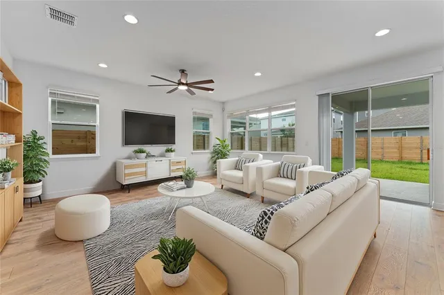 a living room with furniture flat screen tv and a window