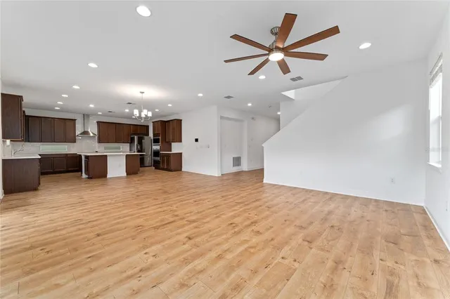 a view of kitchen and a sink with a ceiling fan