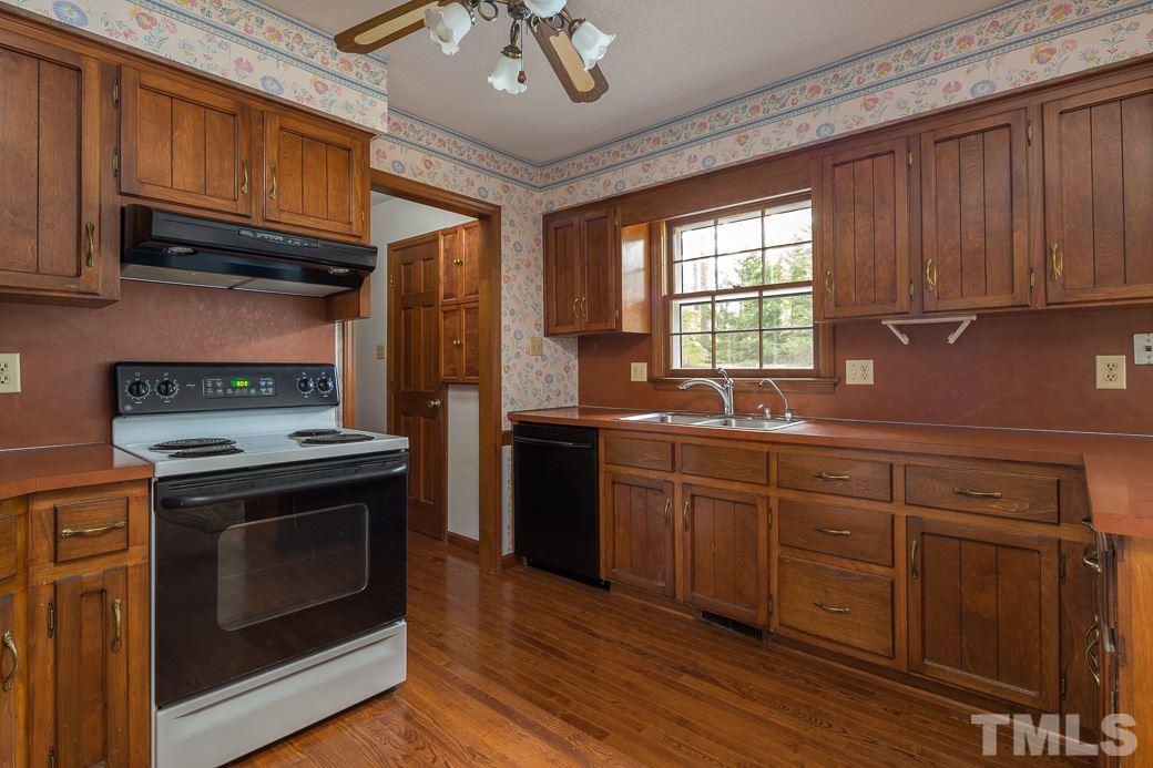 6700 Colony Court Raleigh, NC 27613 - Photo 2 of 21 Kitchen features great wood cabinets and newer sink fixtures.