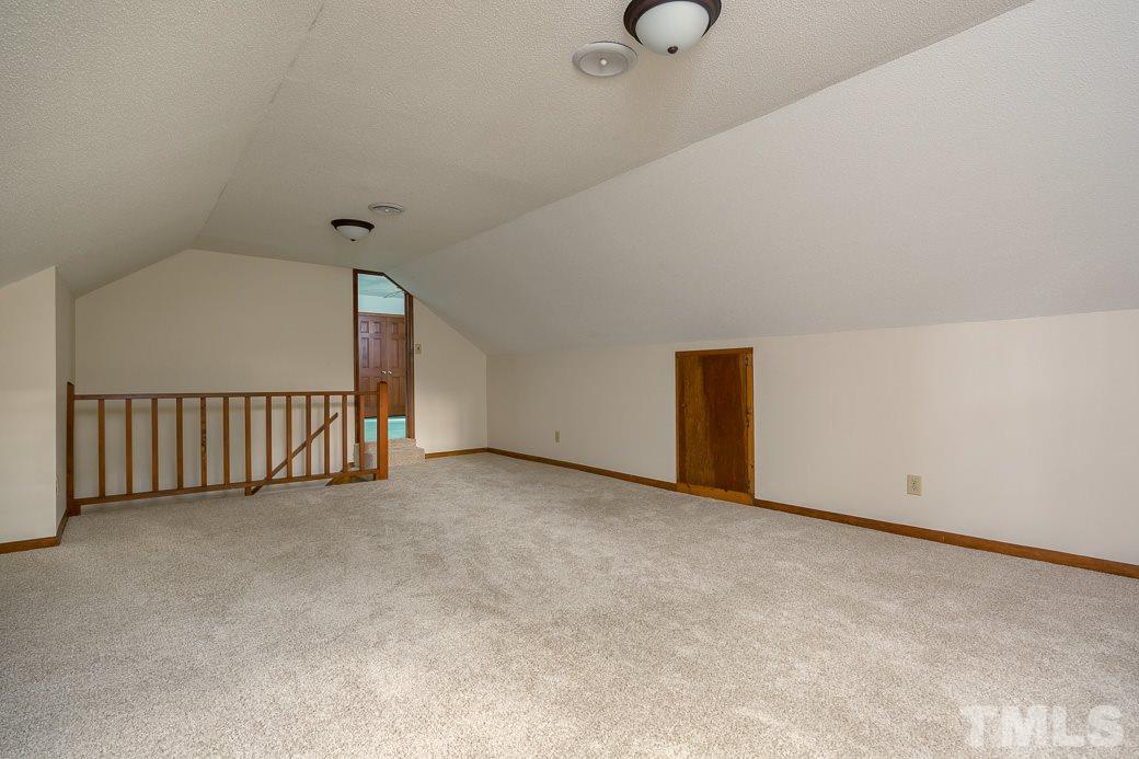 6700 Colony Court Raleigh, NC 27613 - Photo 15 of 21 Bonus room has stair access from kitchen and leads to a secondary bedroom.