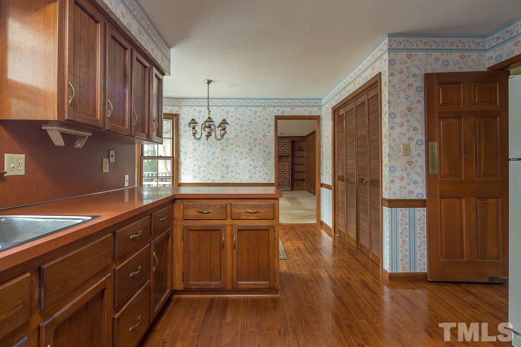 6700 Colony Court Raleigh, NC 27613 - Photo 3 of 21 Huge pantry with accordian doors, hardwoods, and swinging door add to the charm!