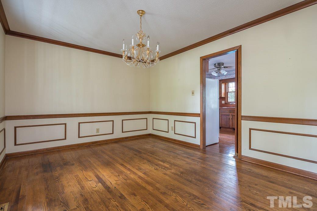 6700 Colony Court Raleigh, NC 27613 - Photo 6 of 21 Large dining room with hardwoods, wainscoting, beautiful fixtures!