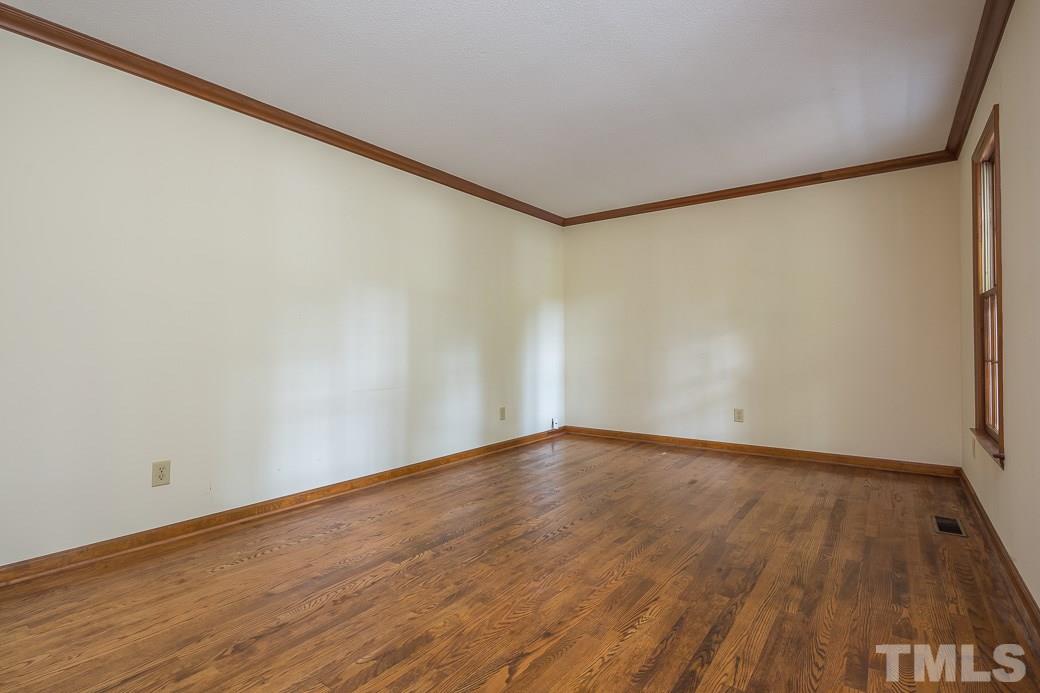 6700 Colony Court Raleigh, NC 27613 - Photo 7 of 21 Formal living room features nicely maintained hardwoods and wood crown molding!