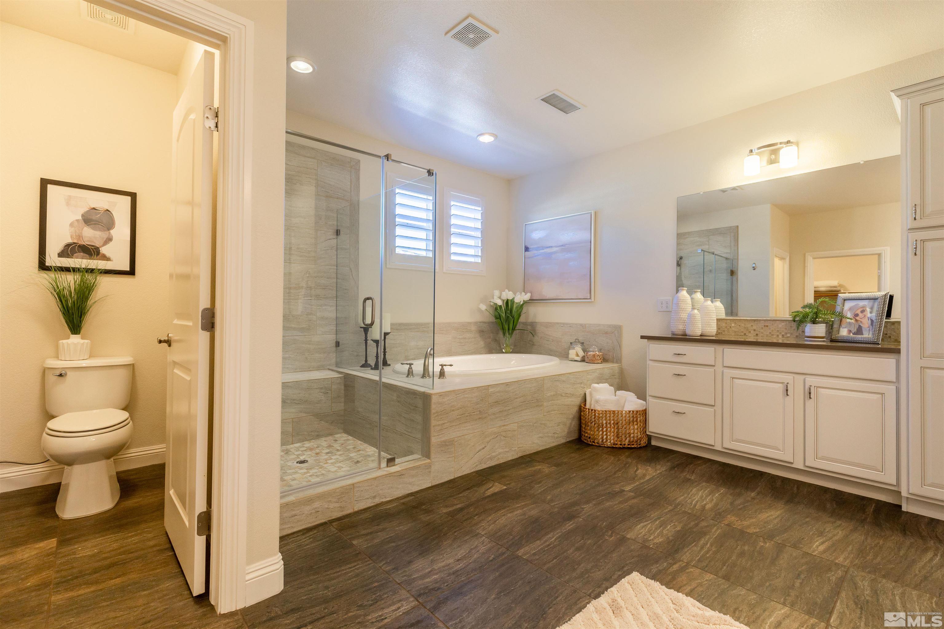 2735 Foxhunter Lane Reno, NV 89521 - Photo 17 of 31 a bathroom with a granite countertop sink mirror vanity and toilet