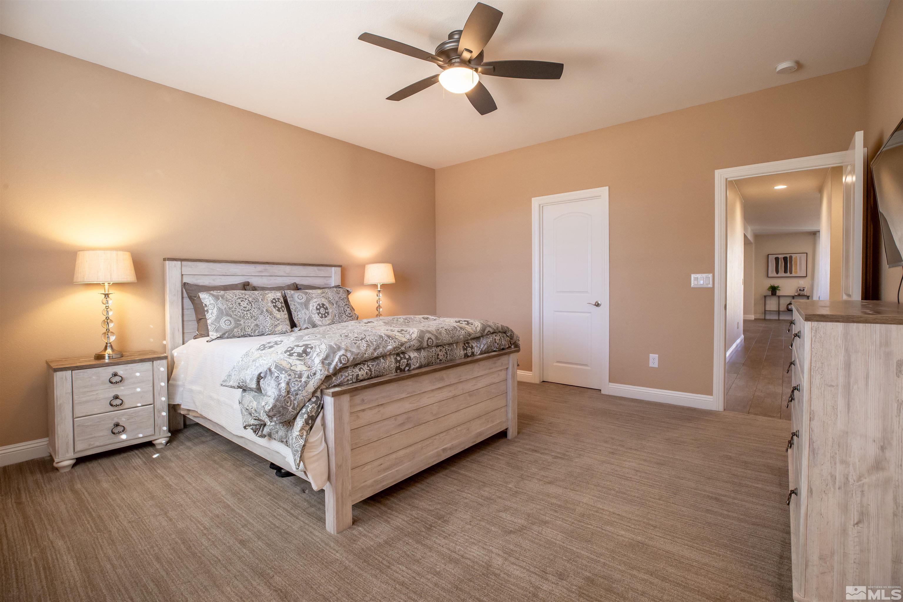 2735 Foxhunter Lane Reno, NV 89521 - Photo 19 of 31 a bed room with a bed and a chandelier