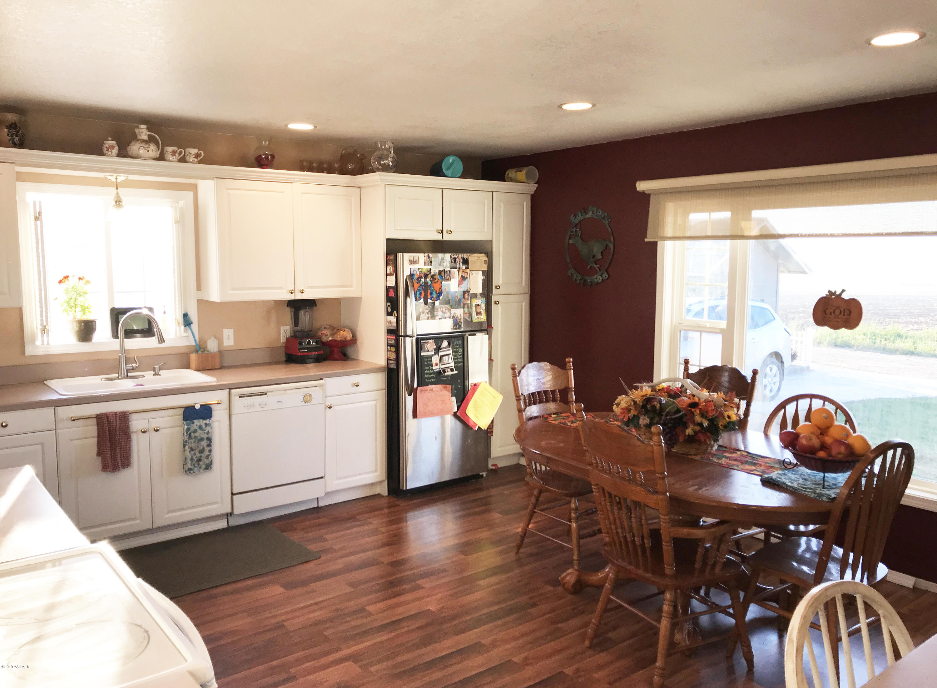 2551 Independence Road Outlook, WA 98938 - Photo 12 of 21 a open dining room with stainless steel appliances kitchen island granite countertop a table chairs a sink and a refrigerator