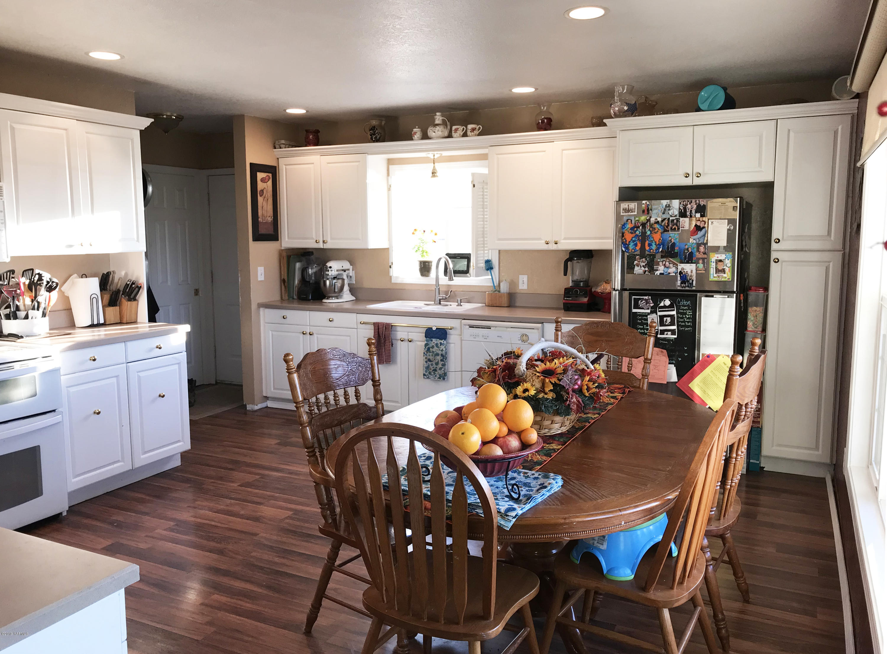 2551 Independence Road Outlook, WA 98938 - Photo 10 of 21 a kitchen with stainless steel appliances granite countertop a dining table chairs and a refrigerator