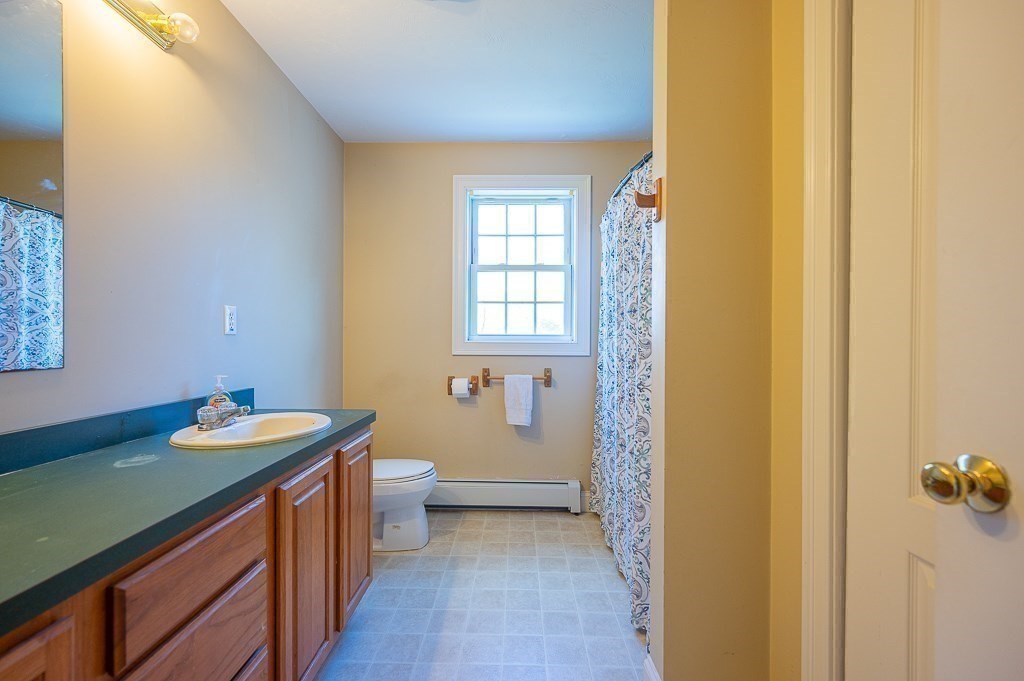 557 Cronin Road Warren, MA 01585 - Photo 18 of 28 a bathroom with a sink a toilet and tub