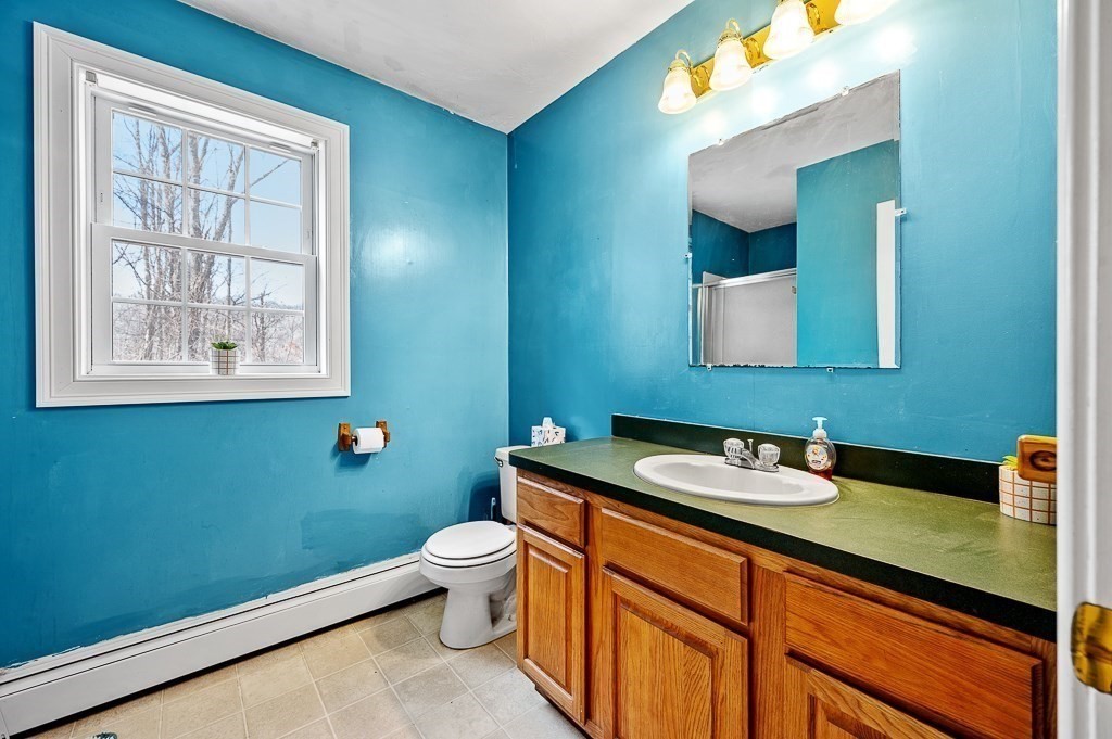 557 Cronin Road Warren, MA 01585 - Photo 20 of 28 a bathroom with a toilet sink and mirror