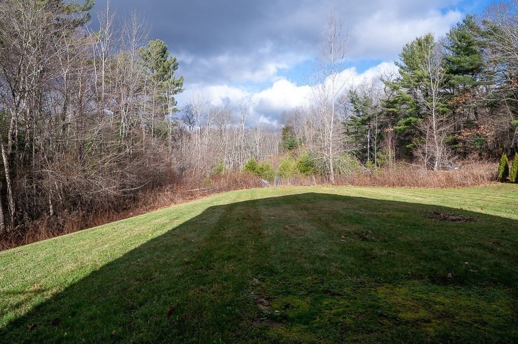 557 Cronin Road Warren, MA 01585 - Photo 25 of 28 a view of a field with a tree in the background