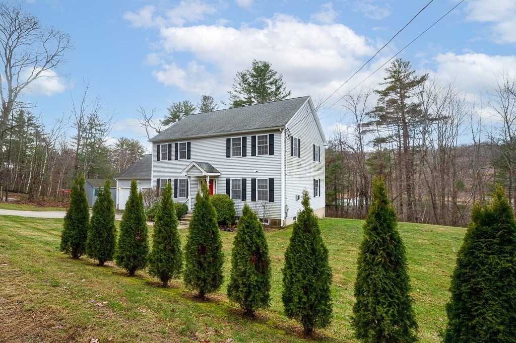 557 Cronin Road Warren, MA 01585 - Photo 27 of 28 a front view of a house with a garden
