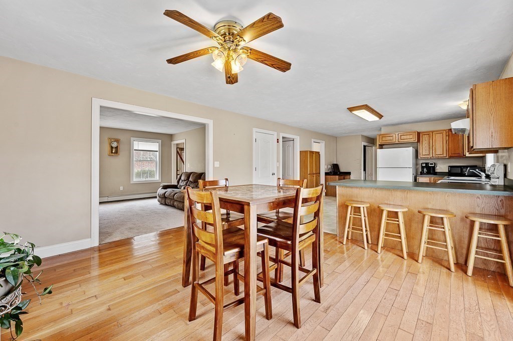 557 Cronin Road Warren, MA 01585 - Photo 6 of 28 a view of a dining room with furniture and wooden floor