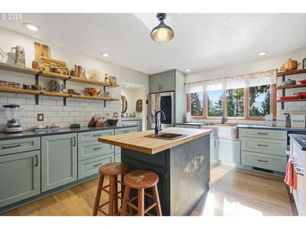 a open kitchen with stainless steel appliances granite countertop a stove refrigerator and cabinets
