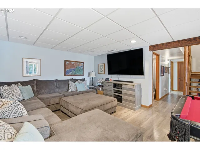 a room with a large bed and wooden floor