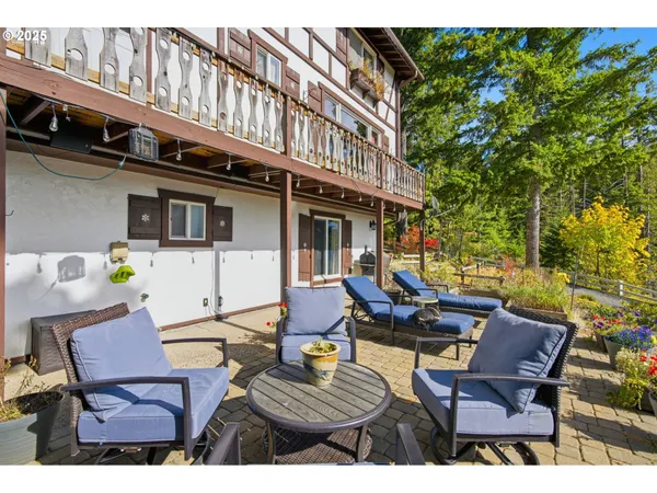 a view of a patio with dining table and chairs with wooden floor