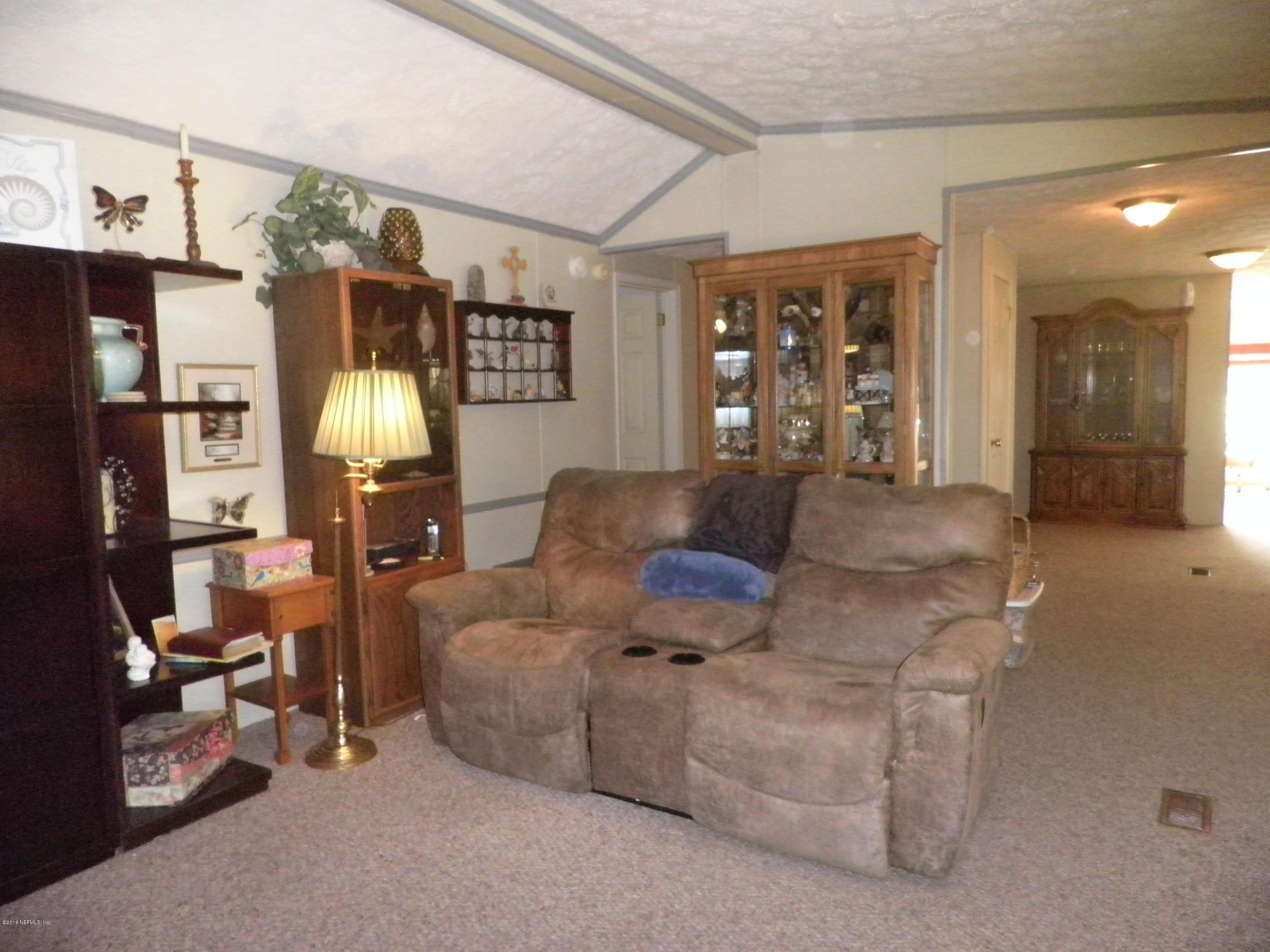 268 Beulah Church Road Welaka, FL 32112 - Photo 13 of 33 a living room with furniture and dining area