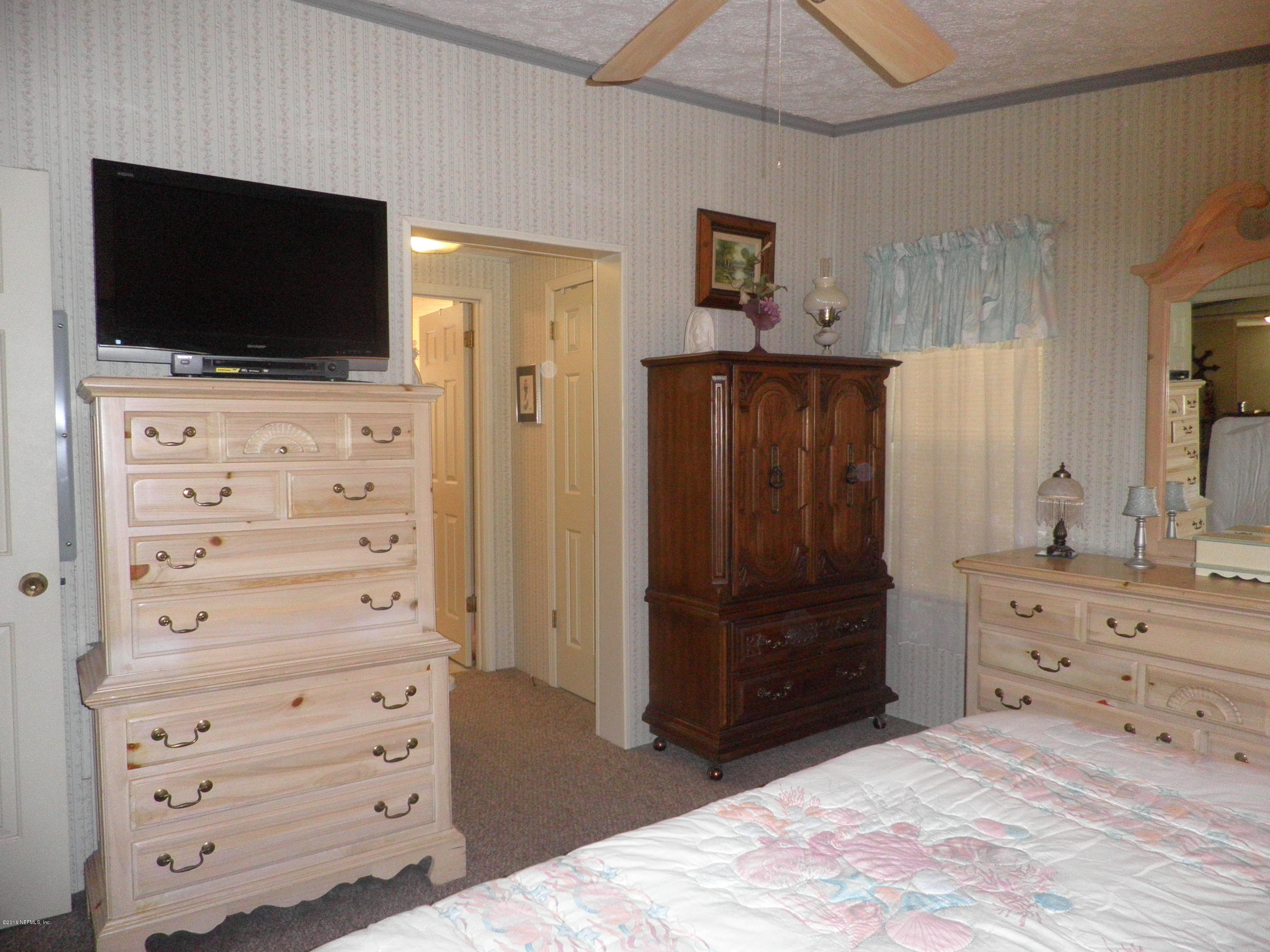 268 Beulah Church Road Welaka, FL 32112 - Photo 16 of 33 a room with a dresser and a television
