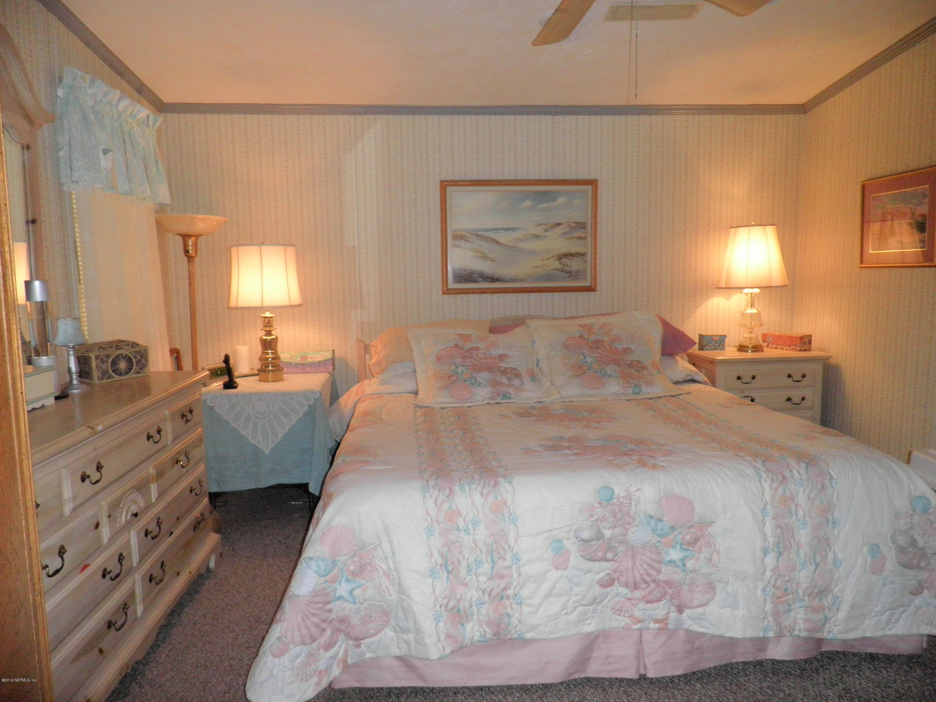 268 Beulah Church Road Welaka, FL 32112 - Photo 17 of 33 a spacious bedroom with a bed and a couch